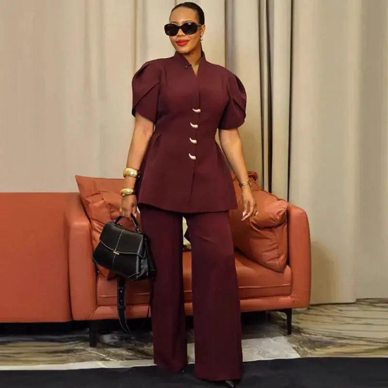 Two-piece burgundy women's suit with puff-sleeve single-breasted blazer and wide-leg pants