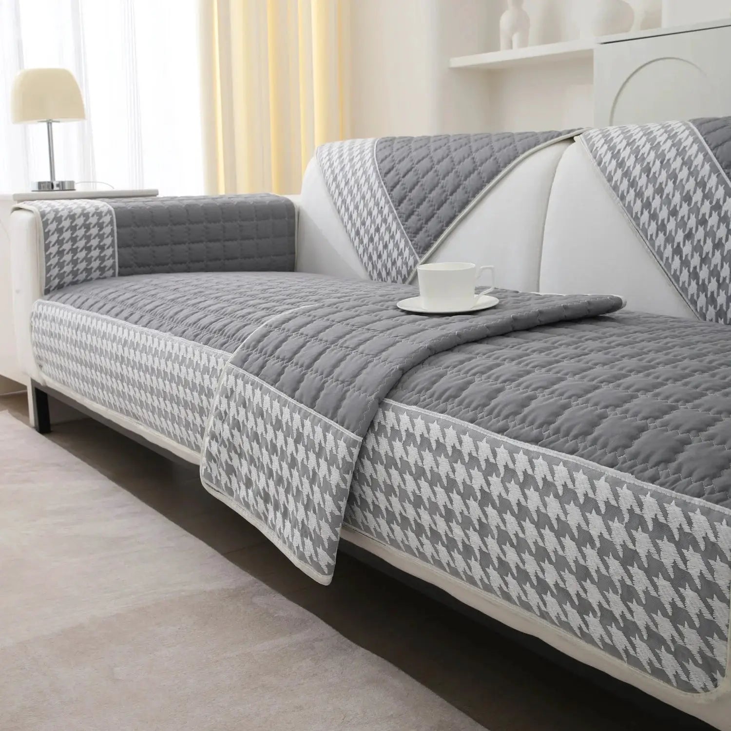 Three-piece houndstooth quilted sofa slipcover set in grey with anti-slip backing