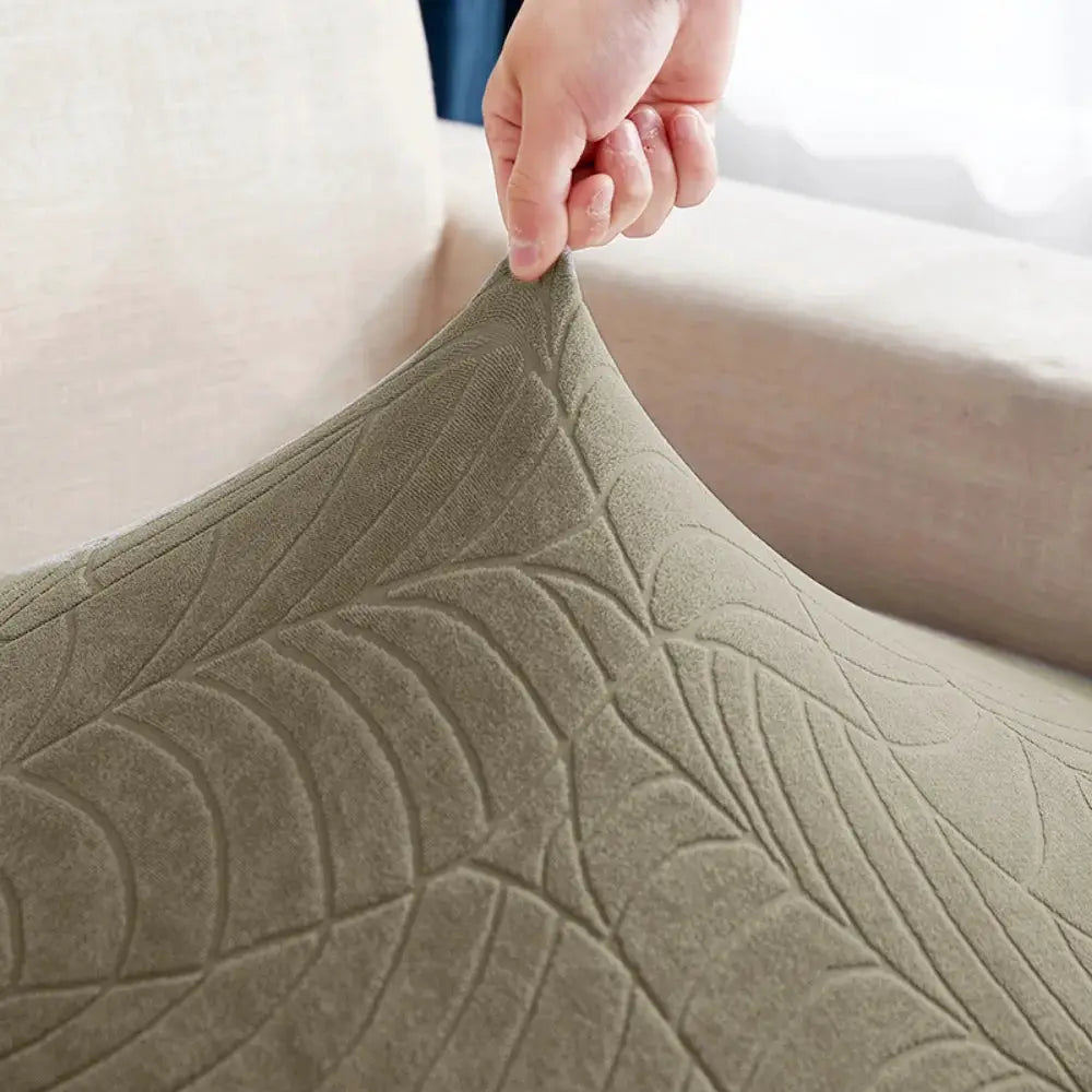 Waterproof stretch sofa cushion cover in beige jacquard fabric with embossed leaf pattern