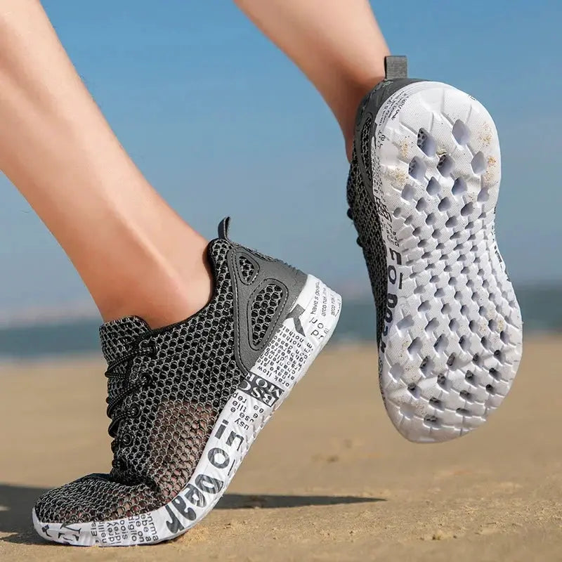 Men's water shoes, black mesh upper and white foam sole, beach-ready pair