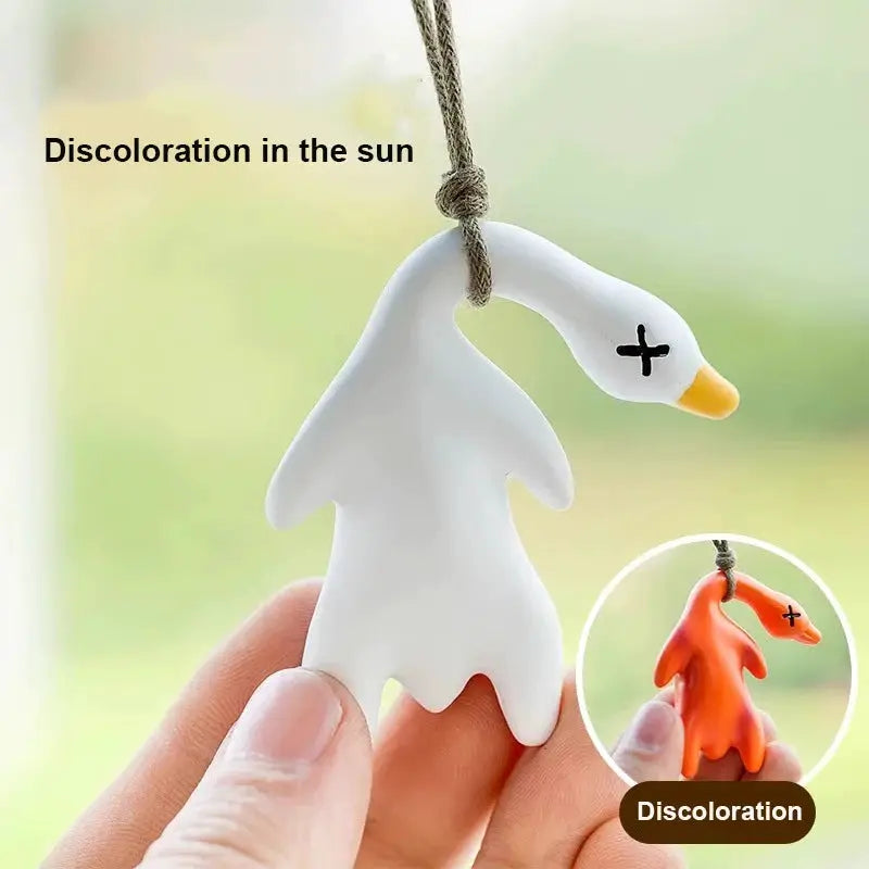 Color-changing roast duck pendant on cord; UV-reactive color shift from white to orange