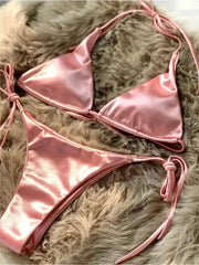 Pink halter bikini set in metallic satin with high-cut bottoms and side-tie straps