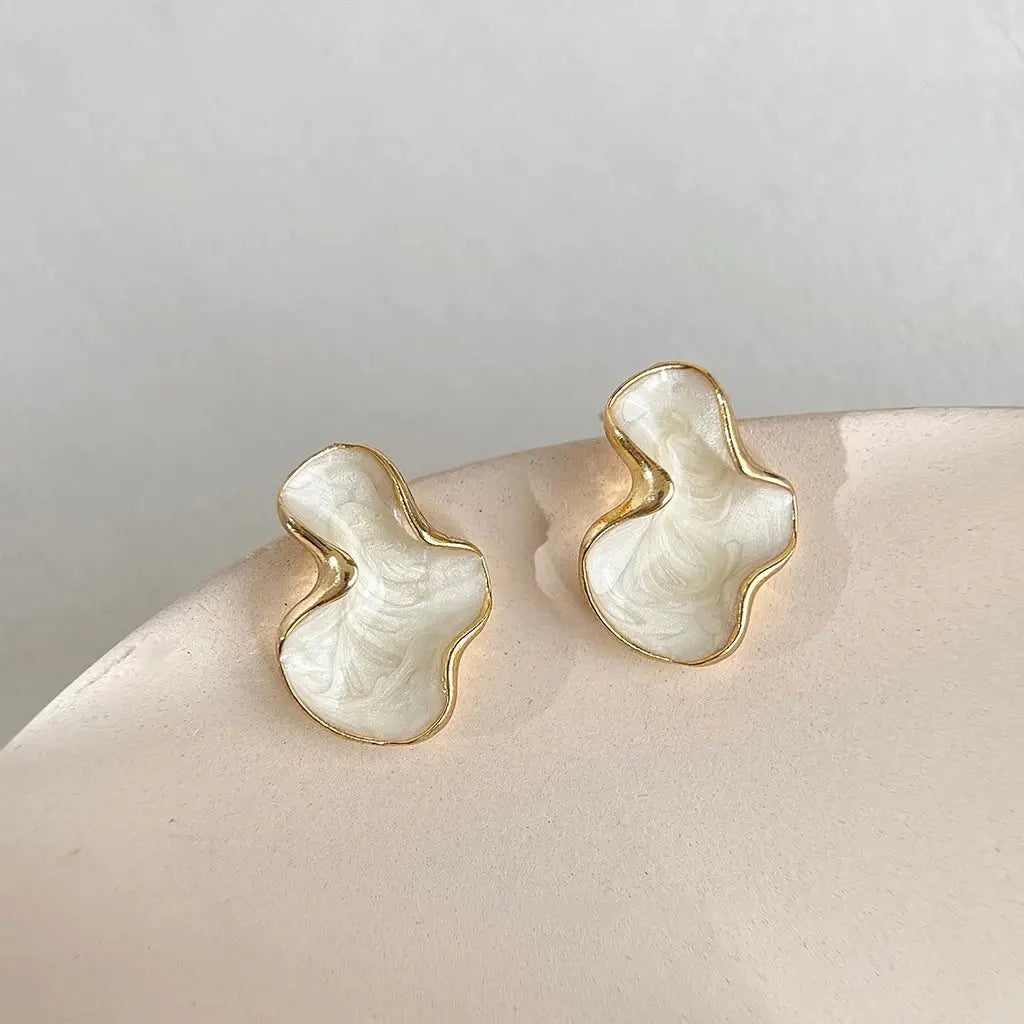 Artistic abstract irregular stud earrings, white marbled with gold edging, pair