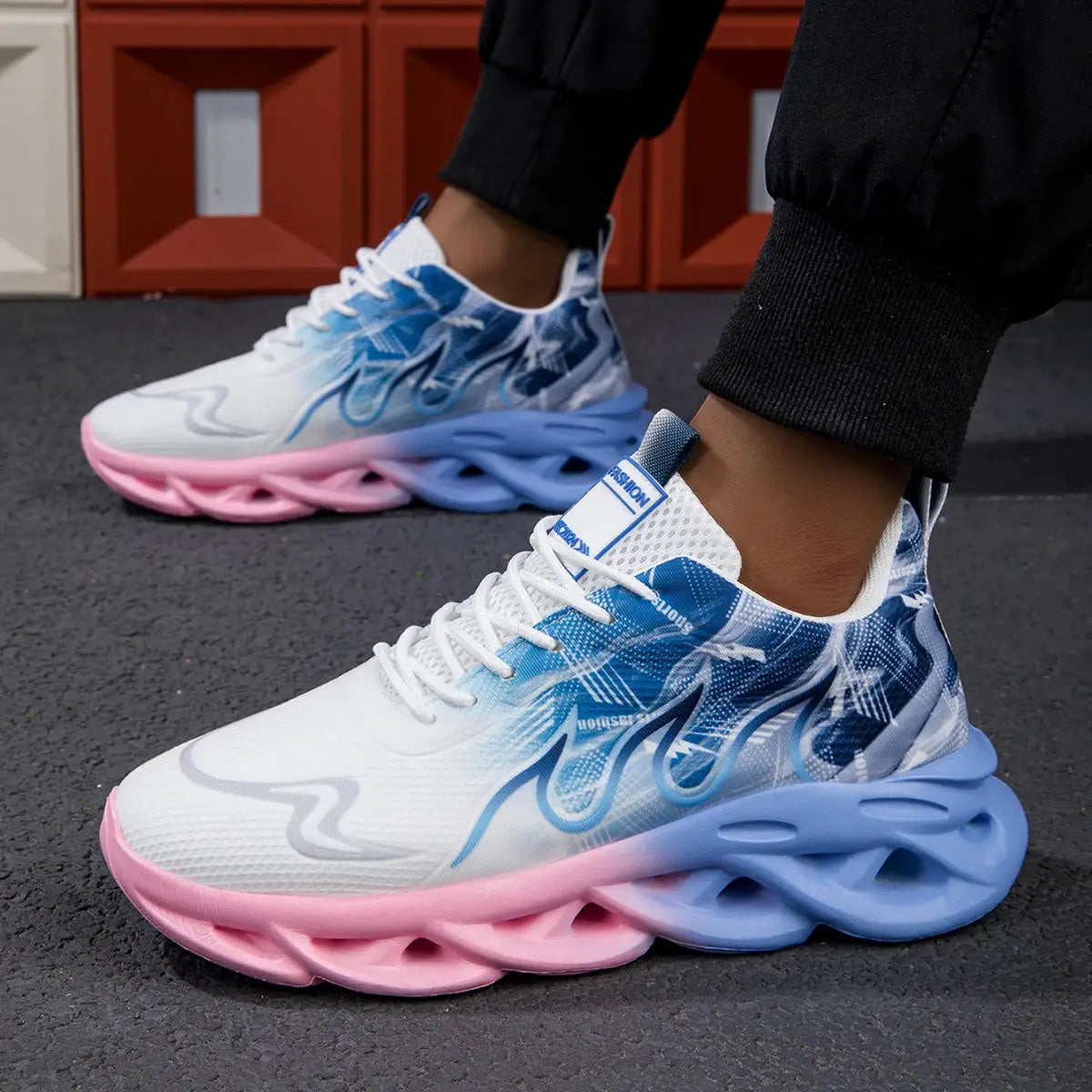 Unisex running shoes with white mesh upper, blue gradient accents, and a pink/blue sculpted sole.