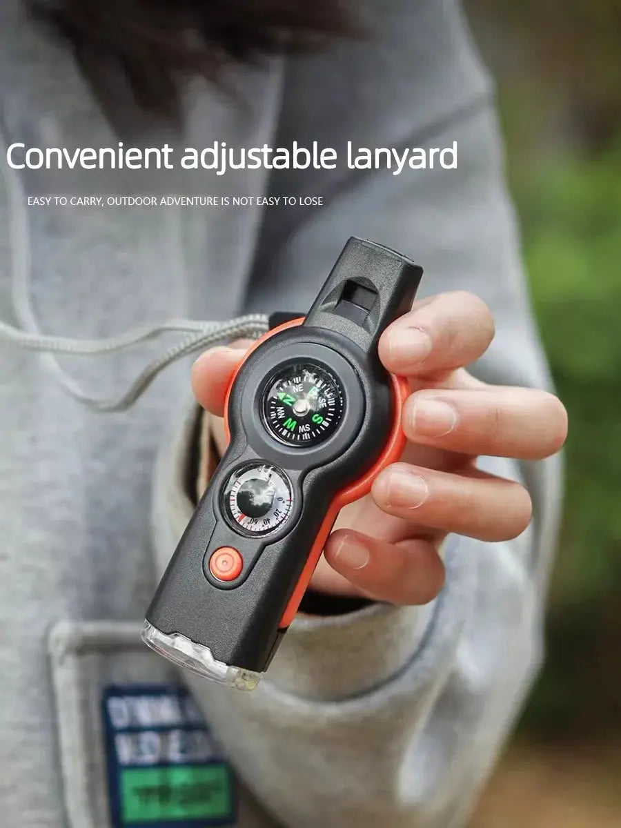 7-in-1 outdoor survival whistle with built-in compass, black and orange handheld lanyard device