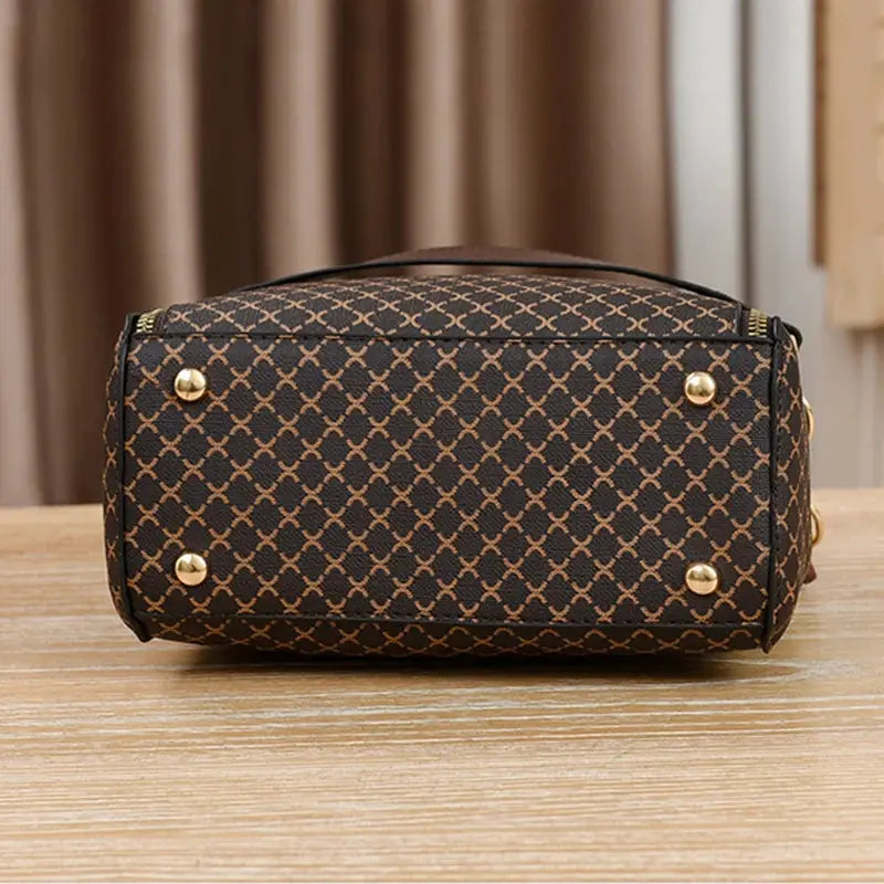 Simples Market women's handbag with brown flip-check print, bucket crossbody style, gold-tone hardware
