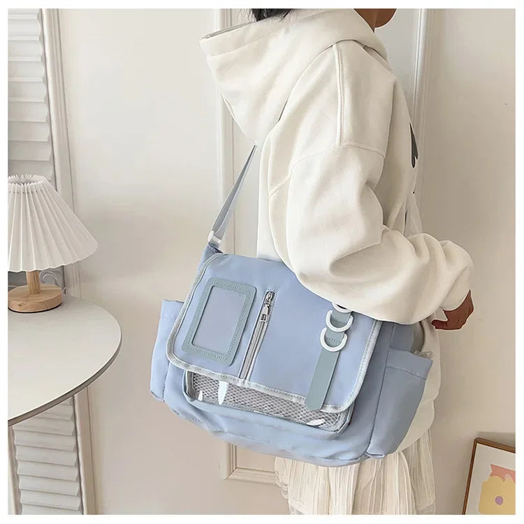 Y2K-style itabag crossbody bag in pastel blue with a clear front panel and ID window, Simples Market.