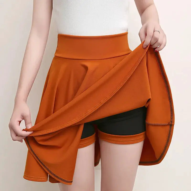 Women's orange flared wrap skirt with black shorts by Simples Market