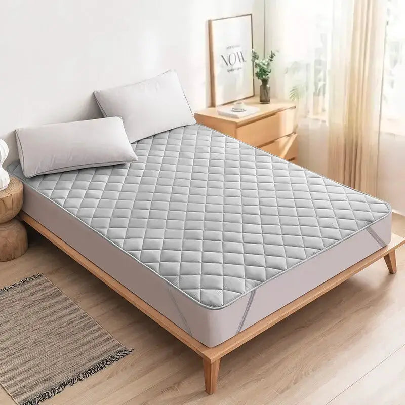 Ultrasonic mattress protector cover pad, washable with elastic band, quilted grey on wooden bed frame