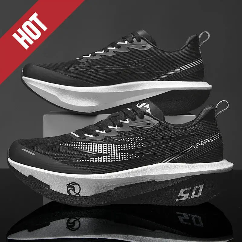 Pair of men's running shoes, black breathable mesh with white midsole, athletic sneakers