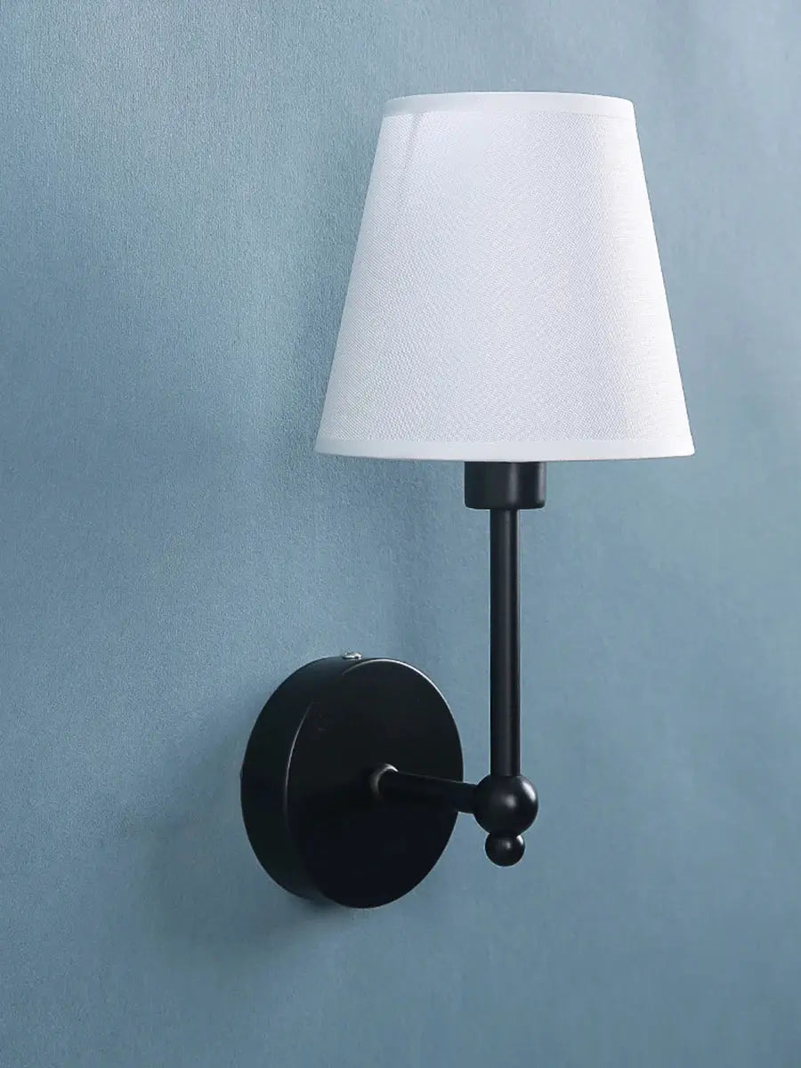 Black metal wall lamp with white fabric cone shade, retro-style bedroom/bathroom sconce.