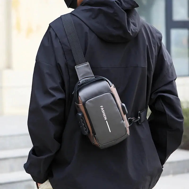 Men’s anti-theft chest bag crossbody with USB charging, black and gray worn across the chest.