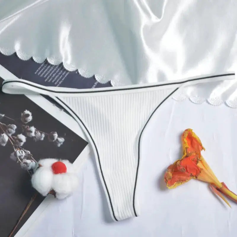 White cotton thong underwear with ribbed texture and black trim, low-rise seamless G-string.