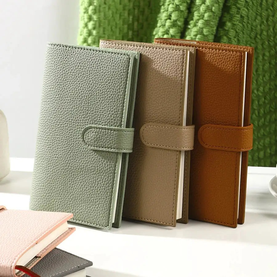 A6 Weekly Planner Notebook set of 3 with compact leather covers in green, taupe, and tan; strap closures by Simples Market