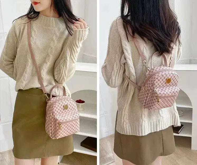 Pink patterned mini backpack by Simples Market with crossbody strap, shown with beige knit sweater and khaki skirt.