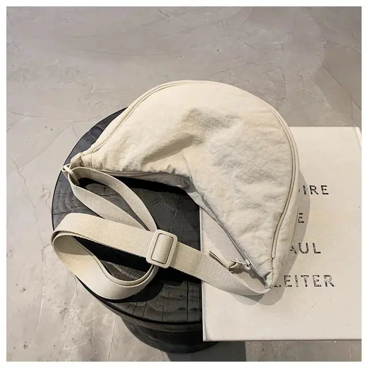 Casual nylon hobo crossbody bag in cream beige with adjustable strap, large-capacity tote.
