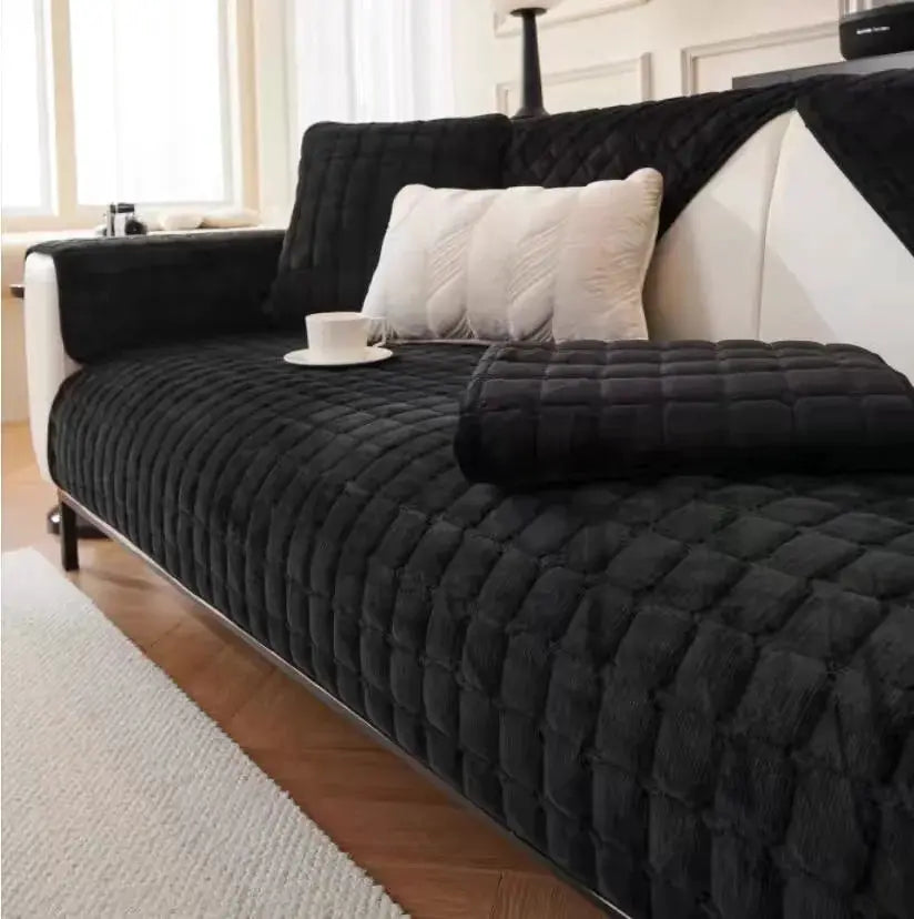 Sofa cover with black quilted plaid flannel non-slip backing and matching cushions on a modern living room sofa