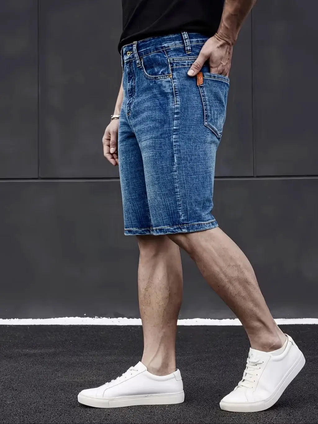 Men's knee-length blue denim shorts with straight, stretch-fit design.