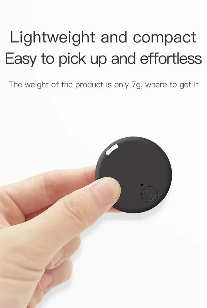 Xiaomi GPS Tracker circular black device held between fingers