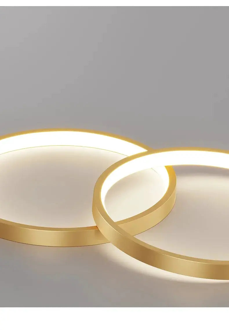 Pair of gold LED ring pendant lights with a minimalist acrylic design for living room or restaurant