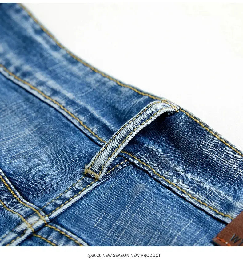 Men's slim denim shorts in blue with belt-loop detail and contrast yellow stitching