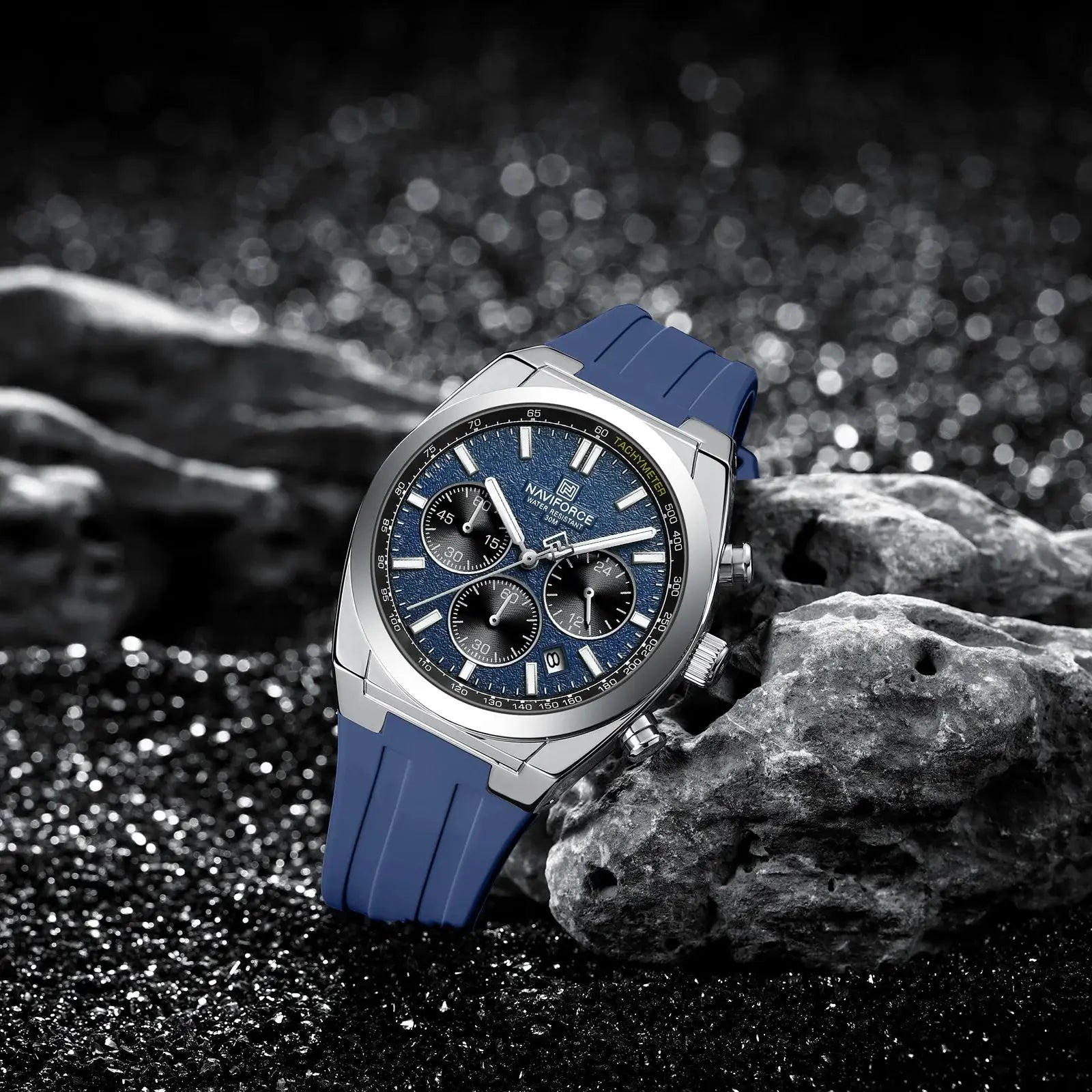 Naviforce 8080 men's quartz chronograph watch with blue silicone strap and tachymeter bezel on rocks