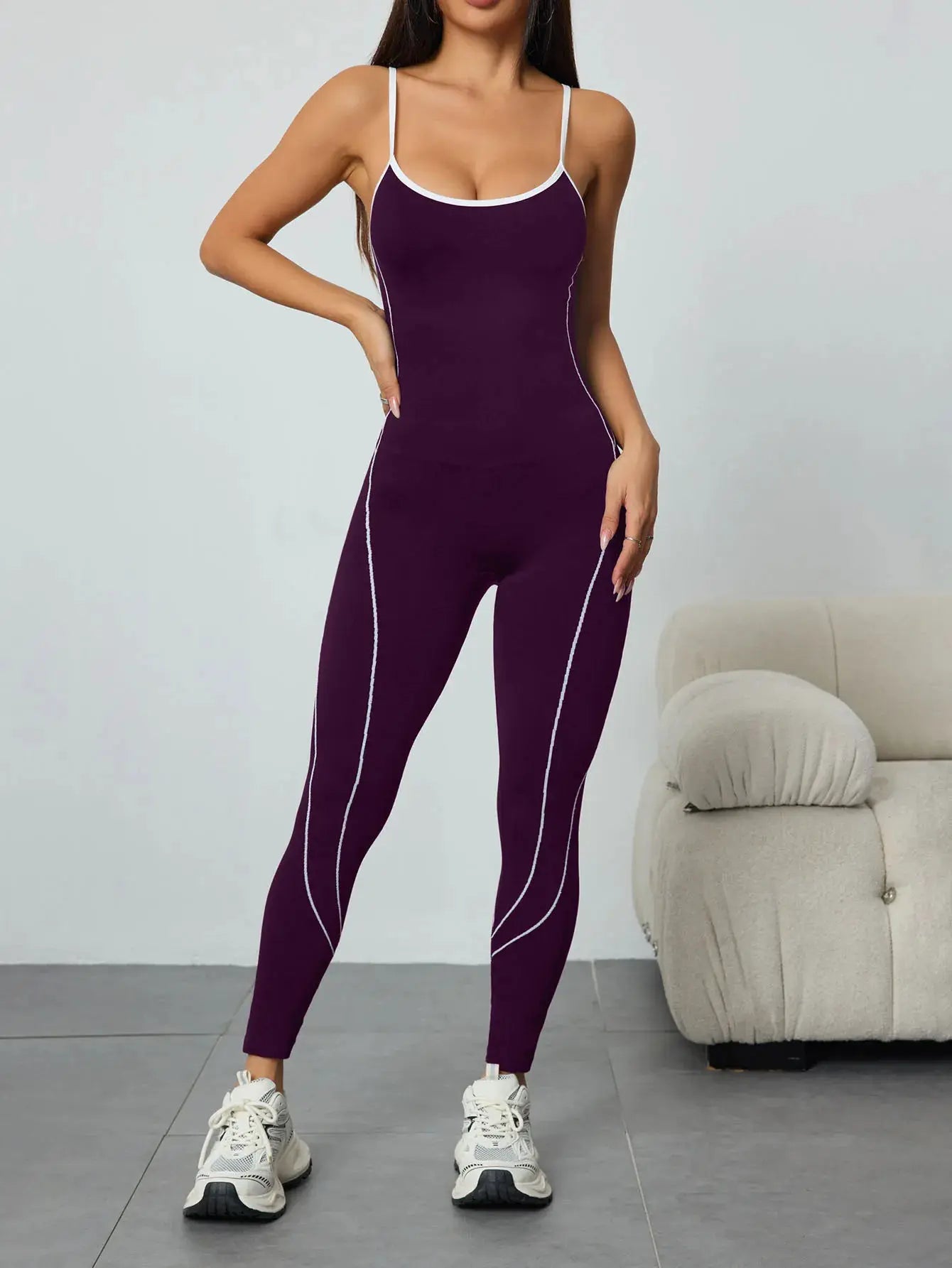 Women seamless yoga jumpsuit by Simples Market in deep purple with white trim and side stripes.