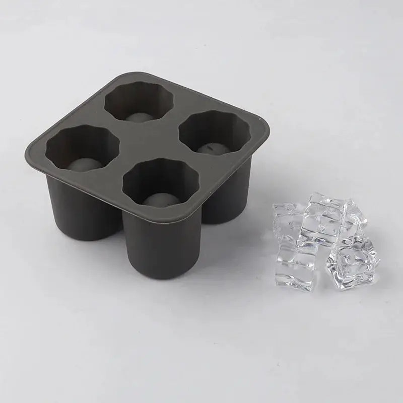 Silicone four-hole ice cube mold, black with round cup-shaped cavities and four clear ice cubes.