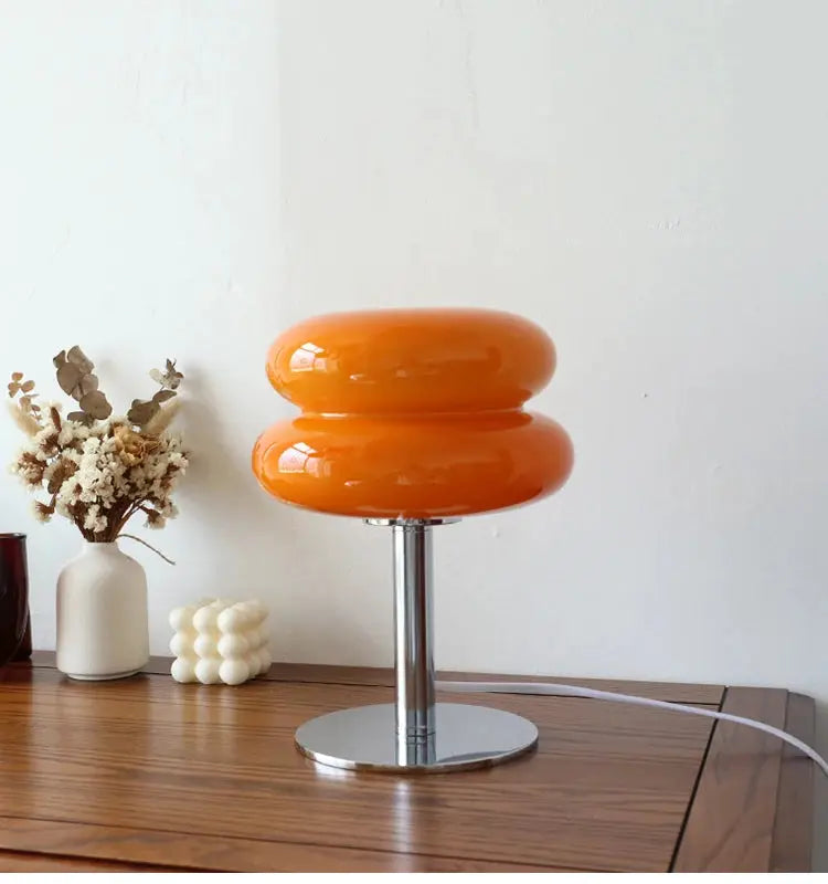 Macaron glass table lamp in orange with chrome pedestal base, ideal as bedside or living room decor.