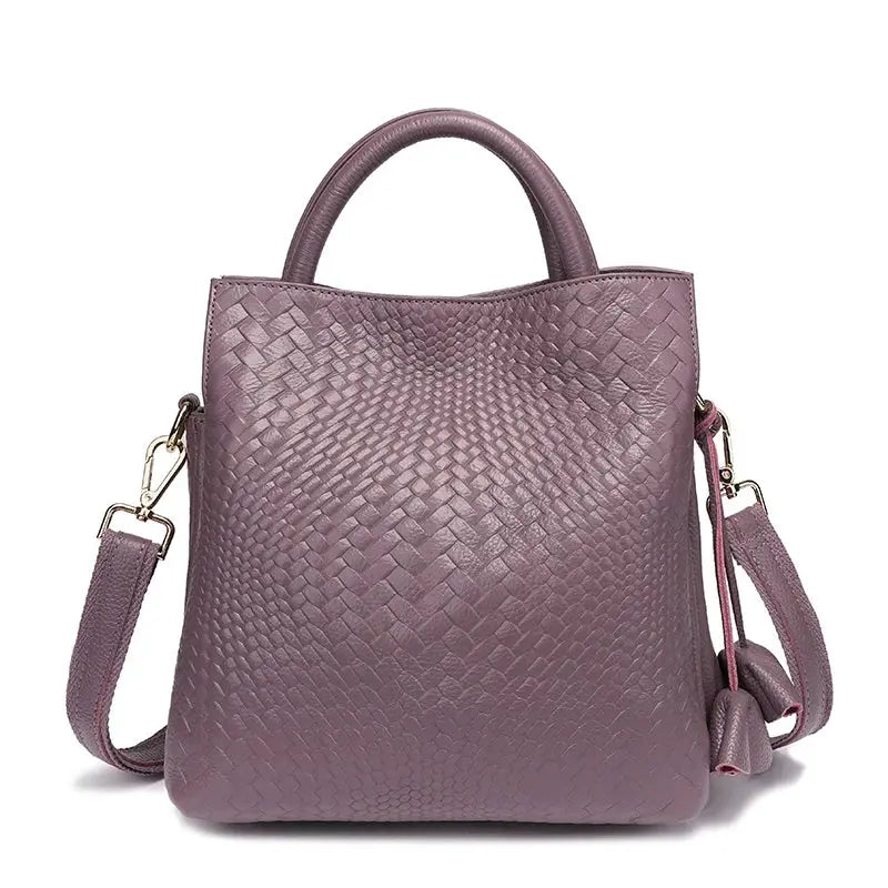 Purple woven cowhide women's handbag with top handle and detachable shoulder strap.