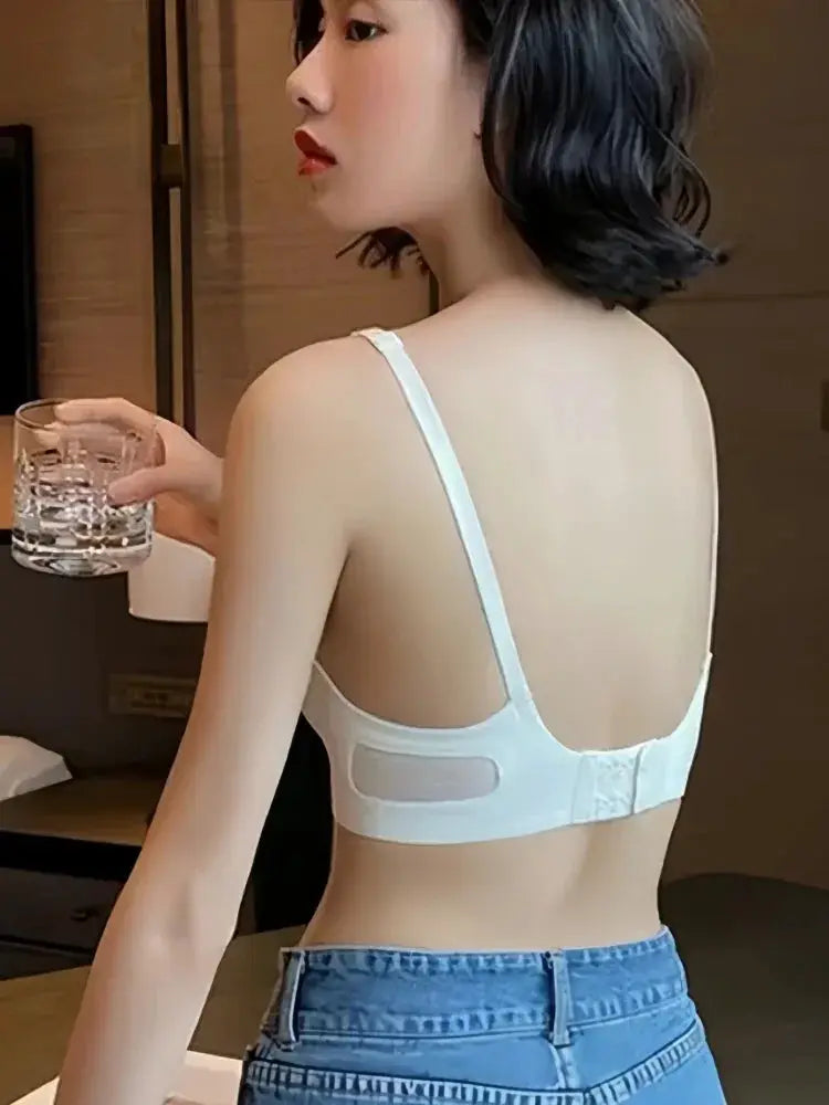 Women's seamless push-up bralette with pads in white, back hook closure, mesh panels.