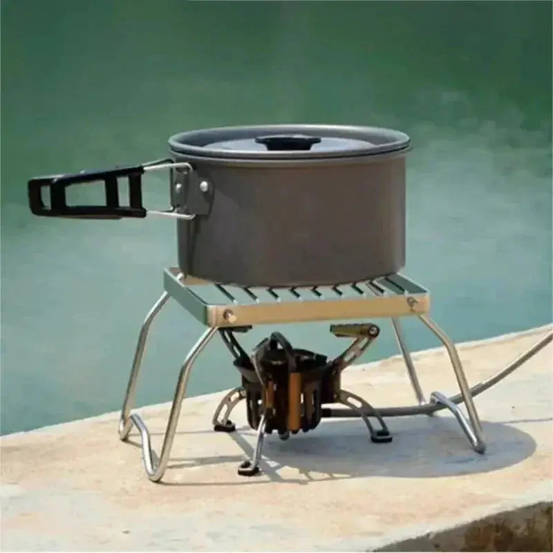 Outdoor stainless steel camping stove by Simples Market with folding grate and pot on top