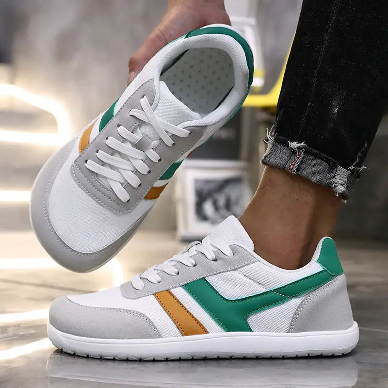 Pair of wide running sneakers, white with green and orange accents, breathable mesh, anti-slip sole
