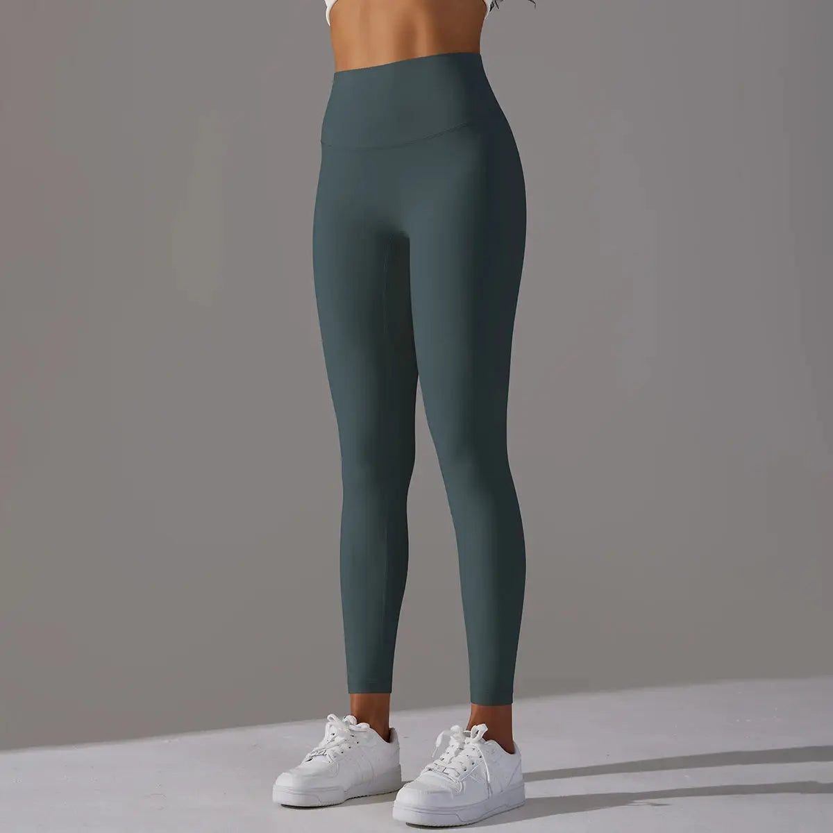 Women's high-waist leggings in dark teal for fitness, running and yoga