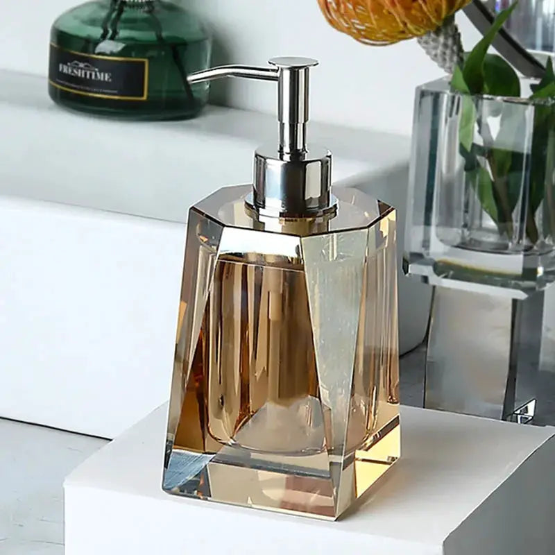 Glass lotion bottle with faceted amber crystal body and chrome pump, bathroom set