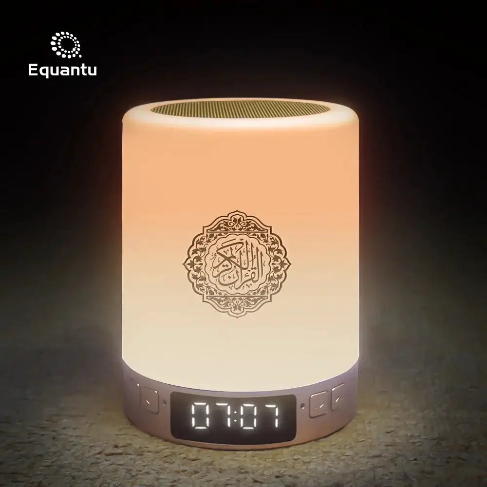 Portable LED night light and Bluetooth speaker by Simples Market, Equantu logo on front and digital clock on base.