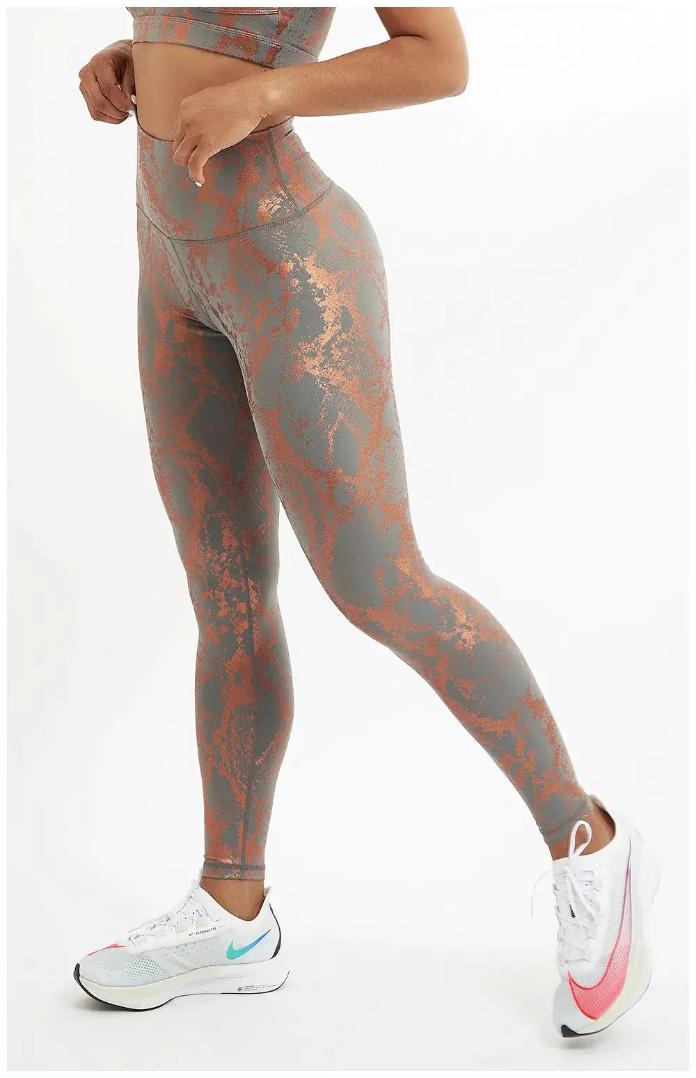 Snake-print yoga leggings in grey with copper metallic pattern, high-waist stretch fit