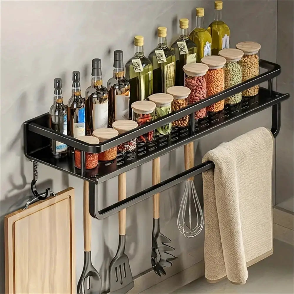 Simples Market wall-mounted black metal storage rack with spice bottles and jars, wooden lids, plus towel rod and utensil hooks.