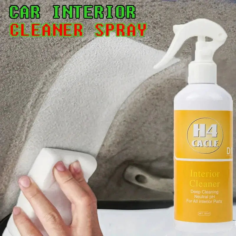 H4 CACLE interior cleaner spray bottle with yellow label, wiping car upholstery with a white cloth