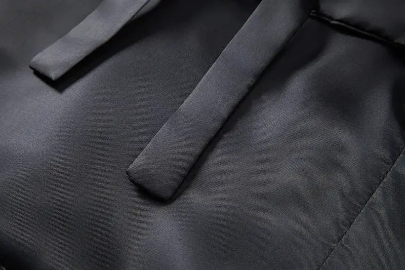 Men's vest fabric close-up from Simples Market; dark gray material with neat seams