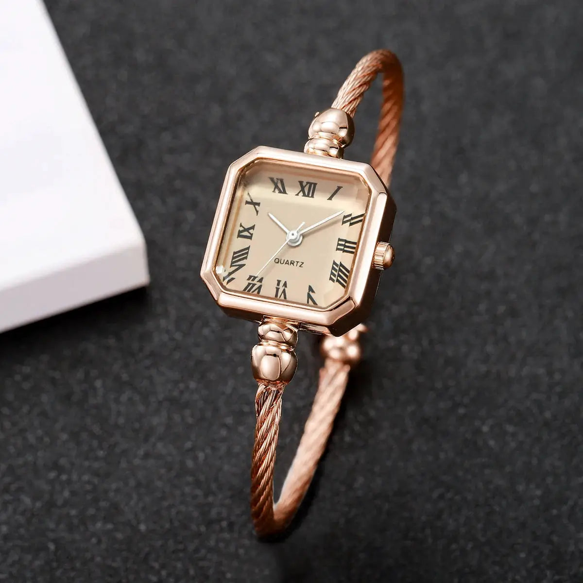 Rose gold women's quartz wristwatch with square Roma dial and twisted bracelet strap