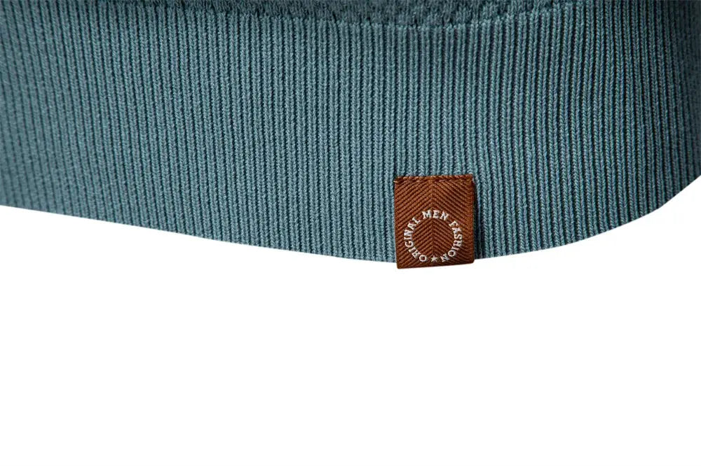Men's blue ribbed golf polo shirt with brown brand patch at the hem