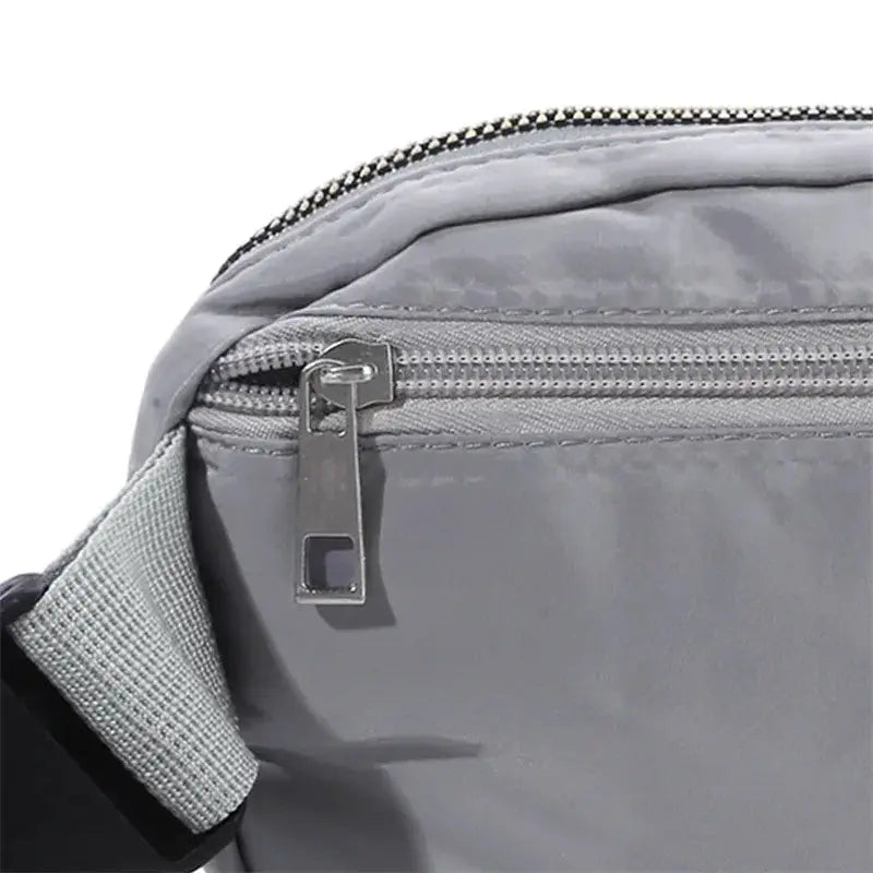 Waist bag in gray with zippered pocket and adjustable strap