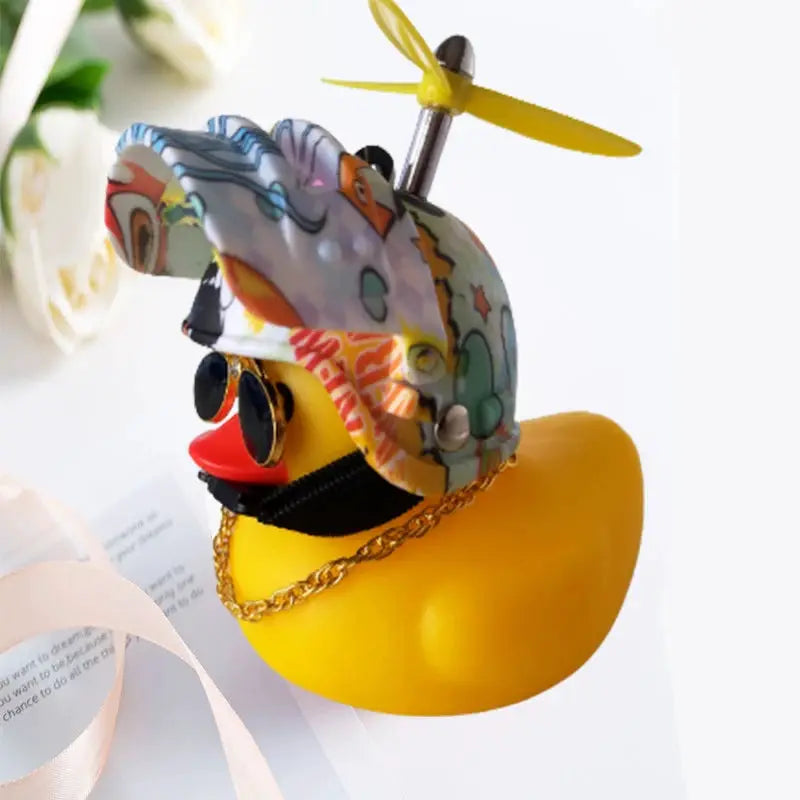 Rubber duck car decor: yellow duck with colorful helmet, tiny propeller, sunglasses, and gold chain