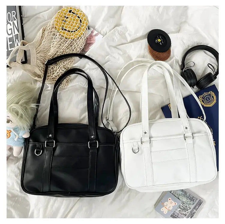 Two Japanese Style JK bags, black and white PU leather shoulder bags with top handles and crossbody straps