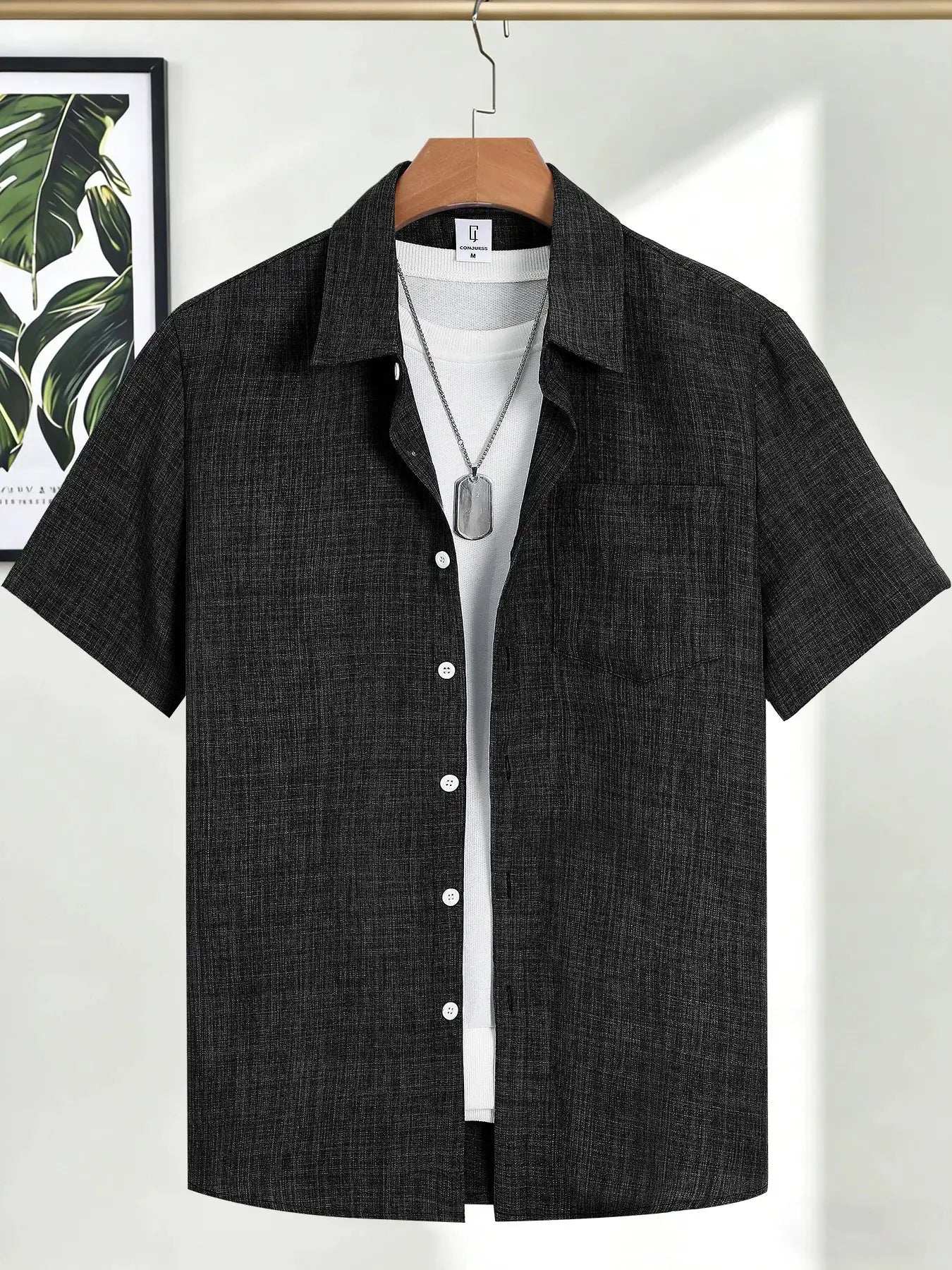 Men's dark gray textured short-sleeve shirt worn over white tee with a silver dog tag necklace