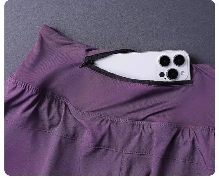 Simples Market women's 2-in-1 shorts with pockets, purple lightweight breathable fabric with zip pocket holding phone