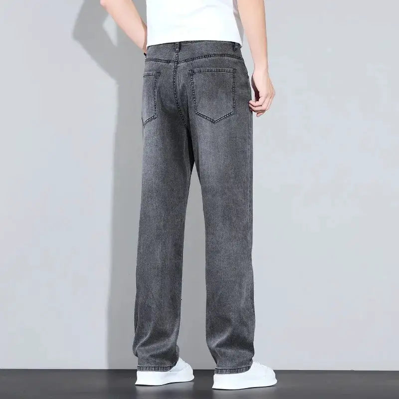 Men's grey washed denim jeans, back view with two rear pockets and straight leg fit.