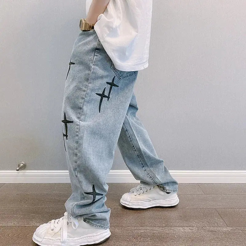 Men's loose denim cargo pants in light blue with black star prints, wide-leg streetwear