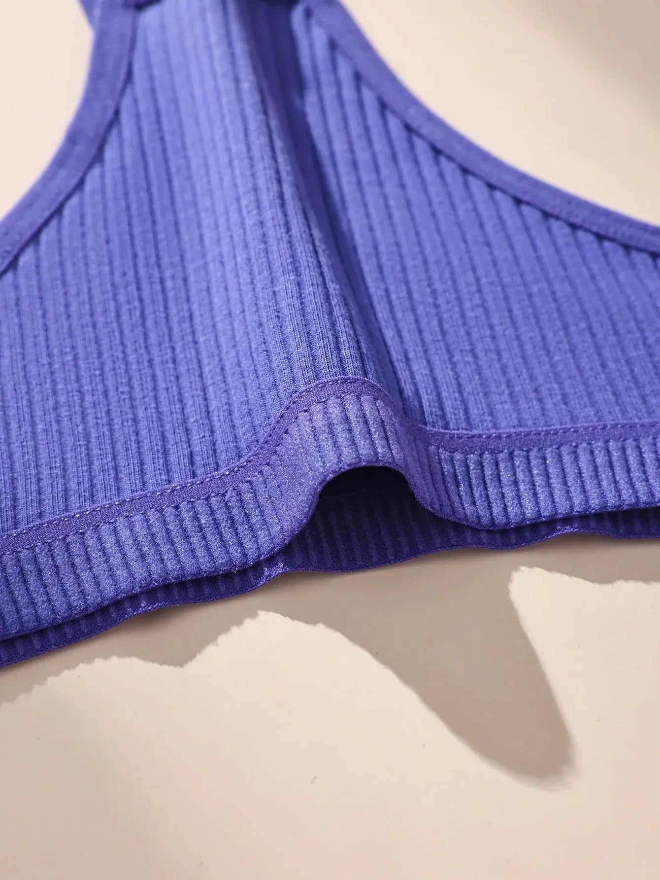 Purple ribbed cotton thong underwear with seamless finish and elastic waistband.
